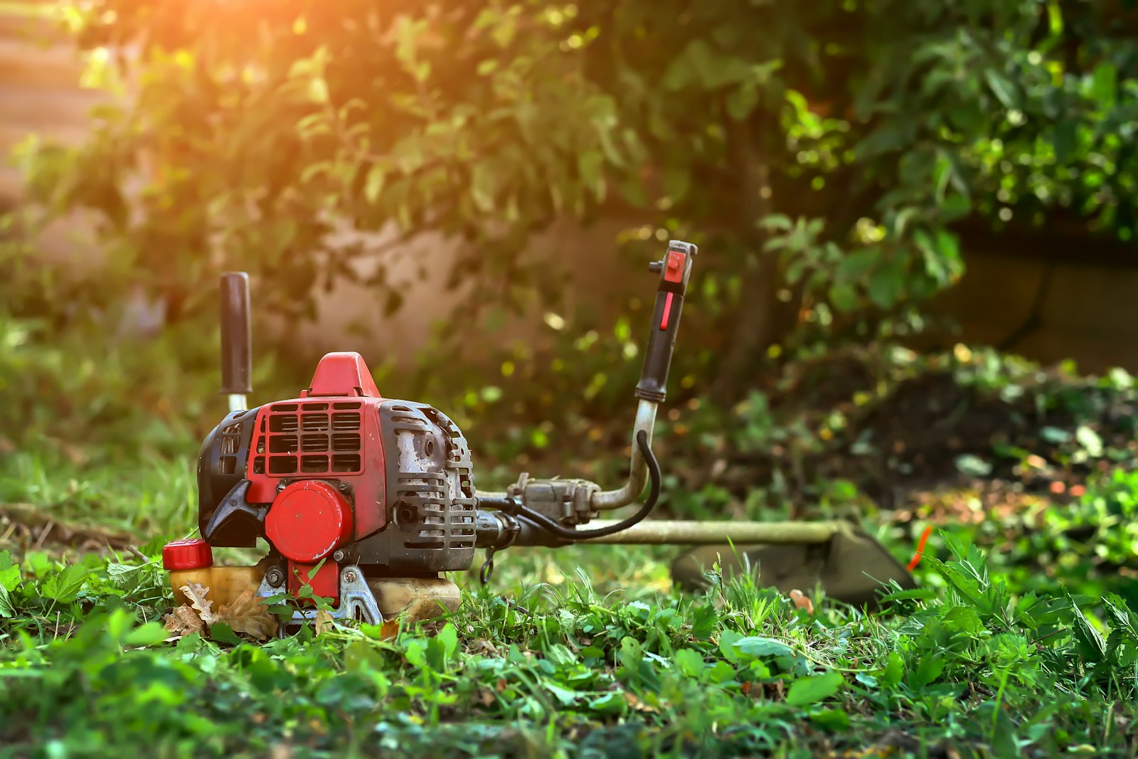 A lawn mower sitting in the middle of a field